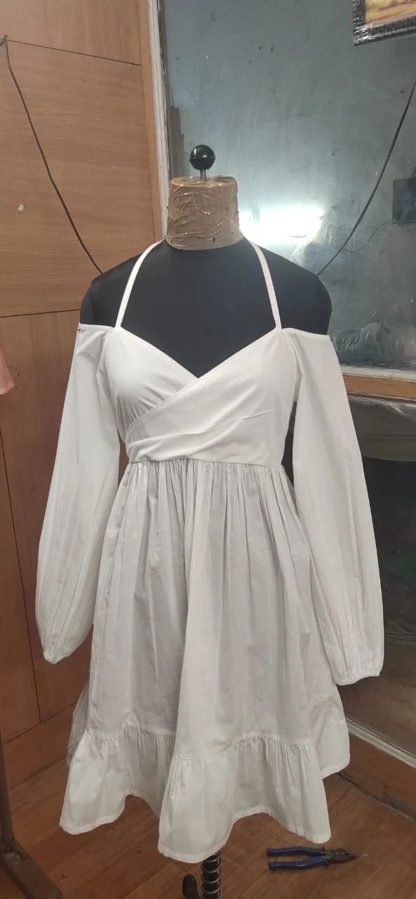 Front view of a white cold-shoulder halter wrap mini dress on a dress form