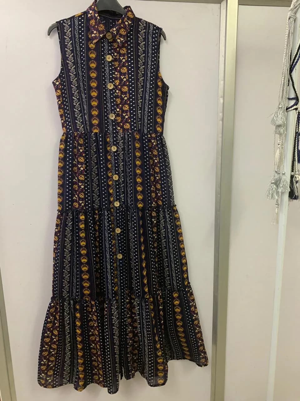 Front view of a navy multicolour ethnic-print button-through tiered maxi dress on a hanger