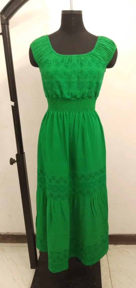 Front view of a green eyelet scoop-neck smocked maxi dress on a dress form