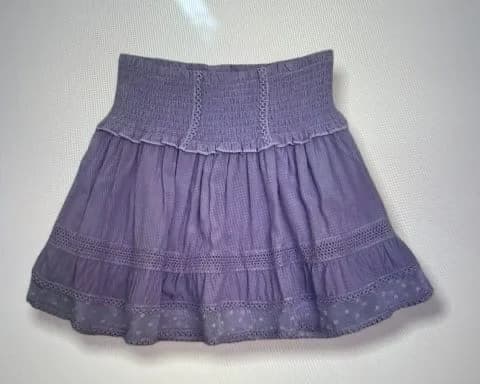 Lilac lace-trim smocked-waist mini skirt laid flat