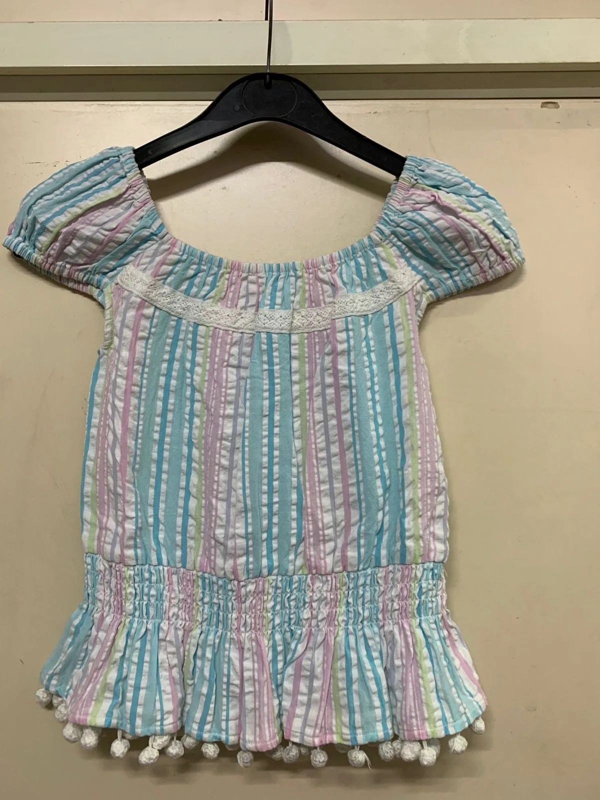 Front view of a pastel stripe pastel stripe seersucker top and skirt set on a hanger