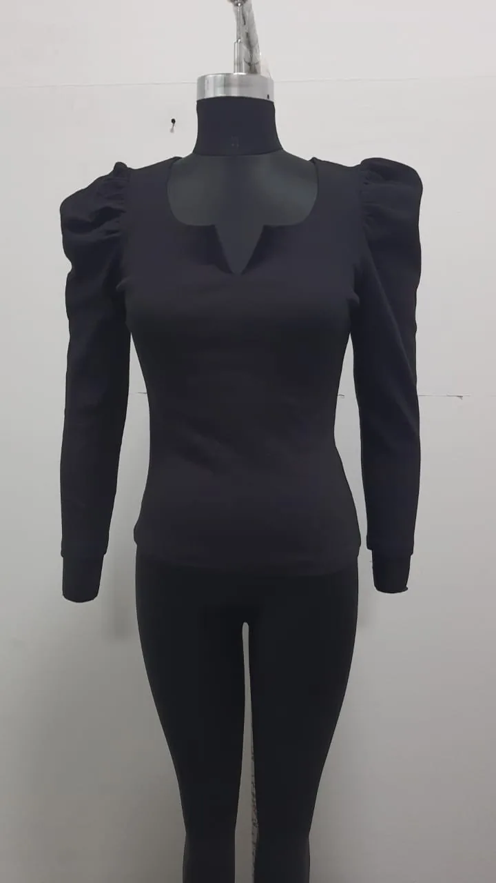 Front view of a black puff-shoulder notch-neck knit top on a dress form