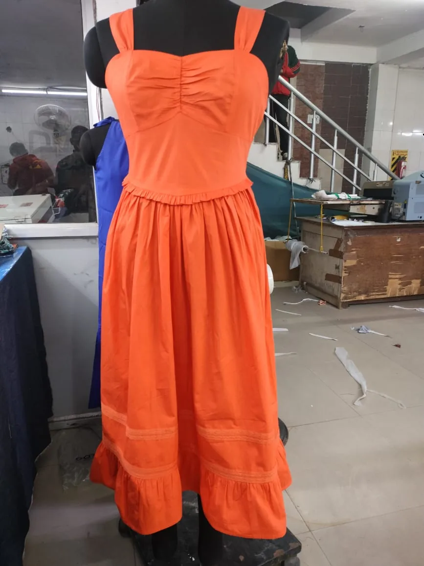 Front view of an orange sweetheart strappy midi dress with lace insertion on a dress form