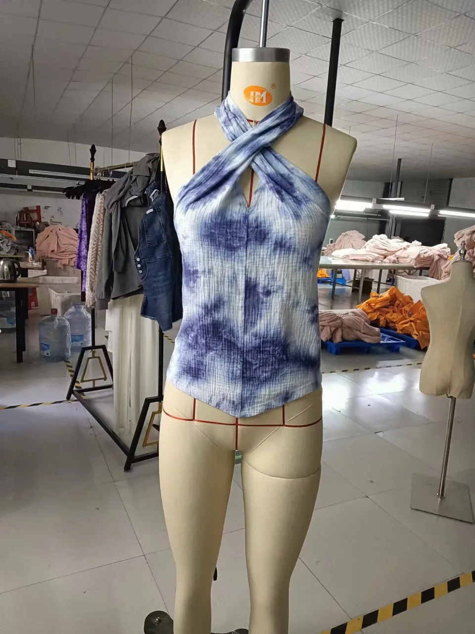 Front view of an indigo tie-dye cross-halter top on a dress form