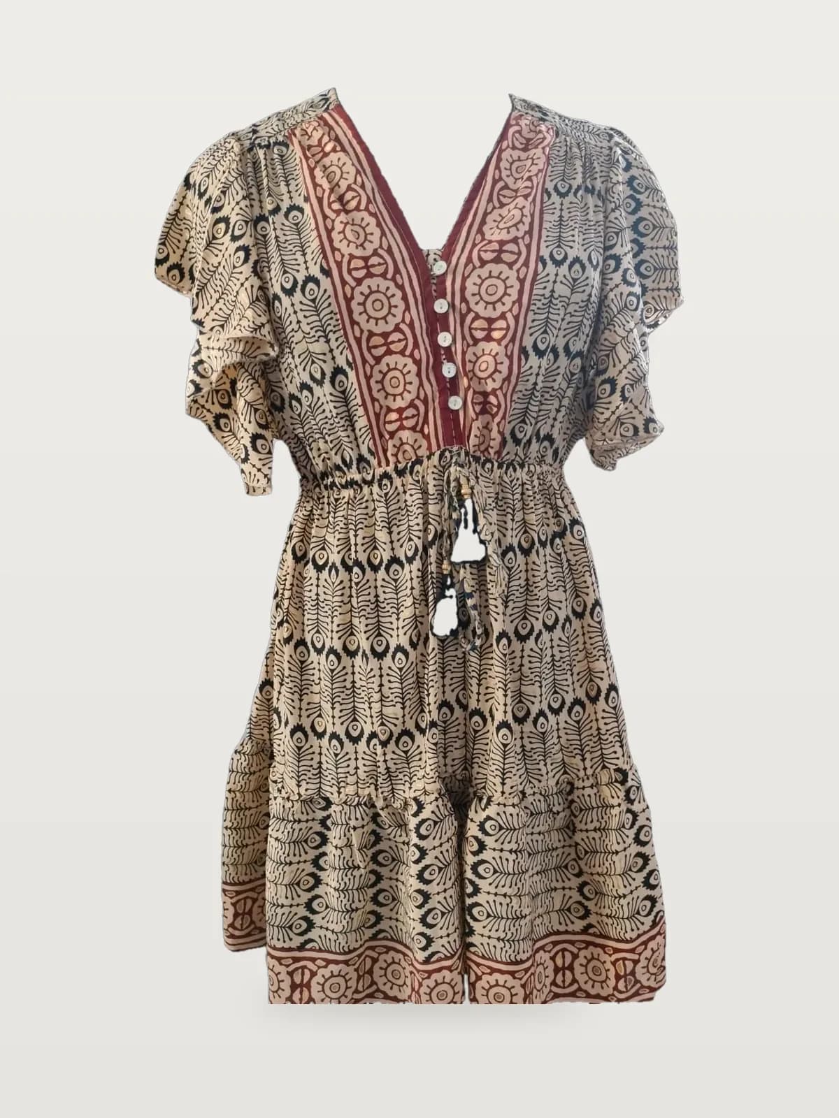 Front view of a cream, black and maroon block-print flutter-sleeve tiered mini dress on a dress form