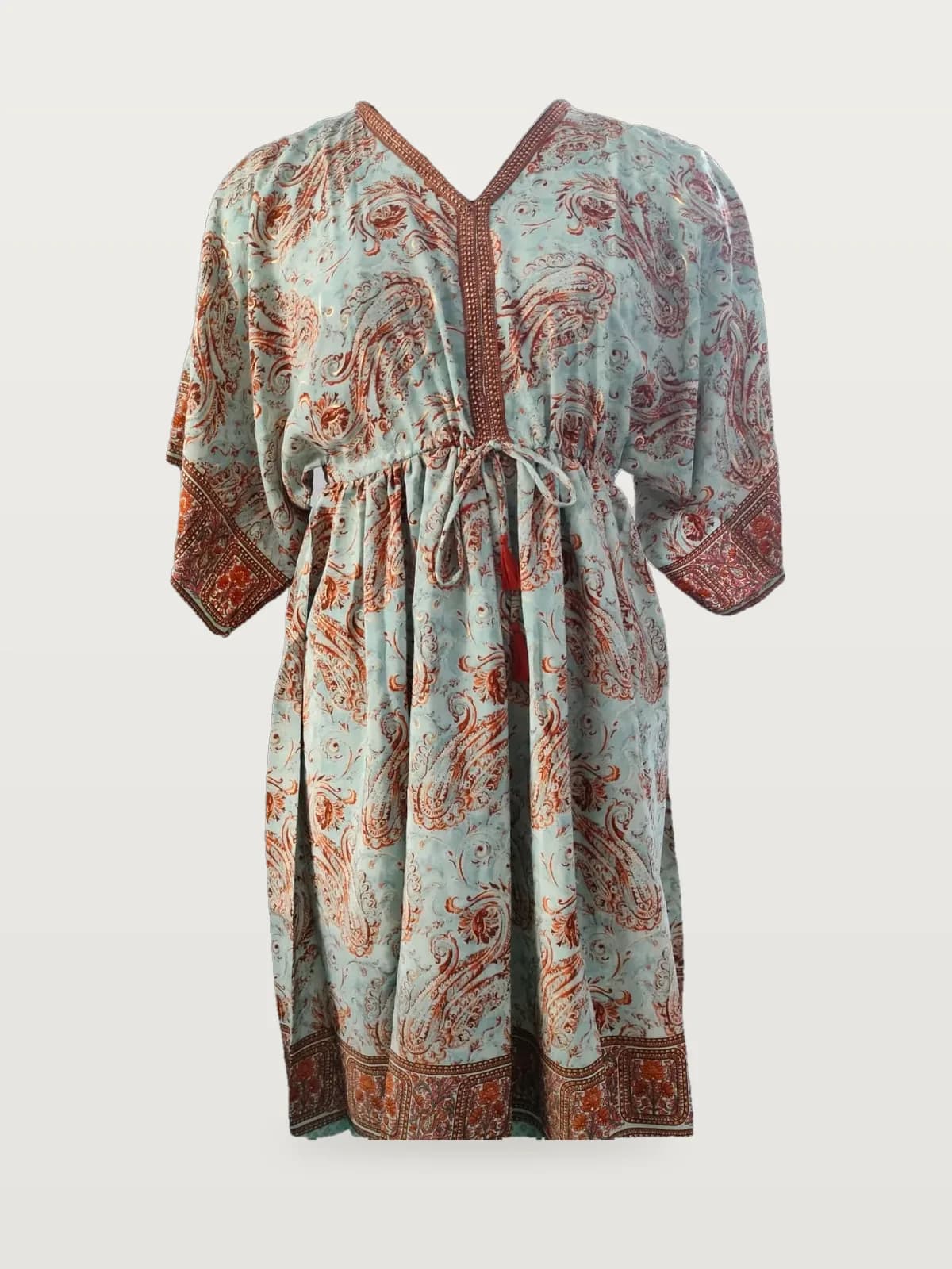 Front view of a mint and rust border-print paisley kaftan with tie waist on a dress form