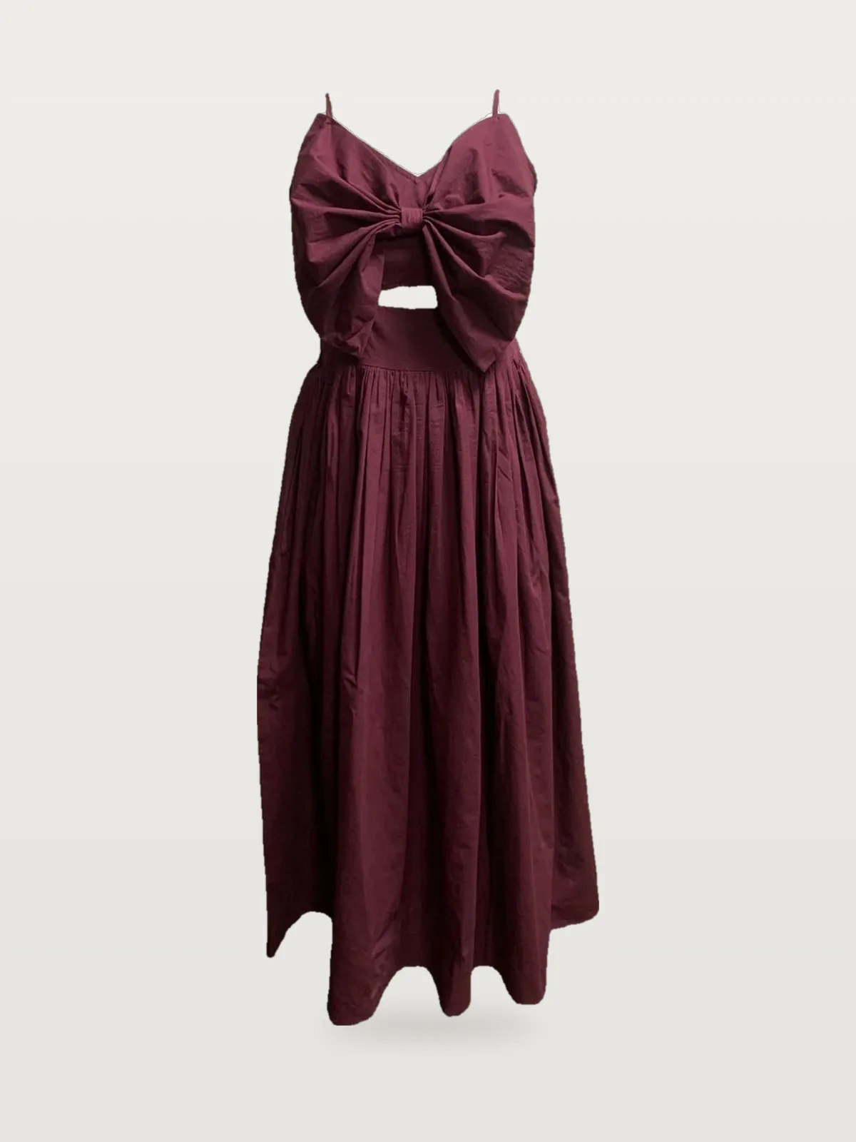 Front view of a burgundy bow-front cut-out midi dress on a dress form