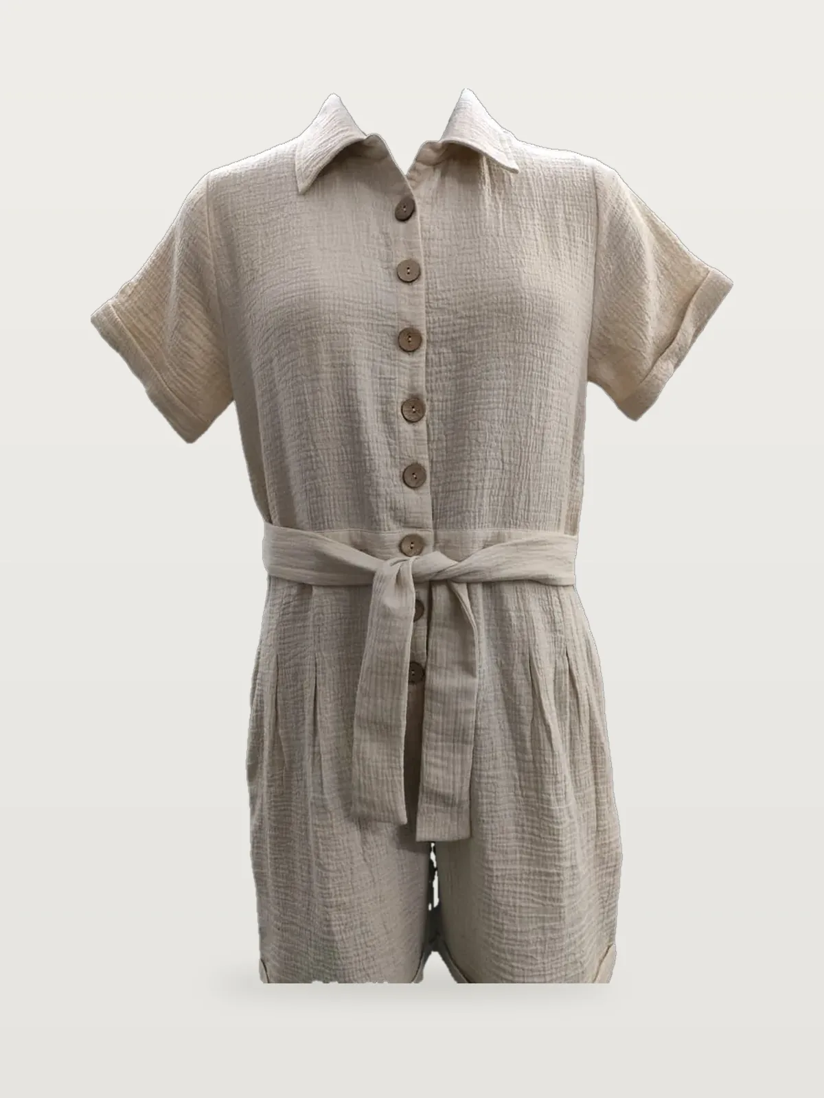 Front view of a beige crinkle cotton belted playsuit on a dress form