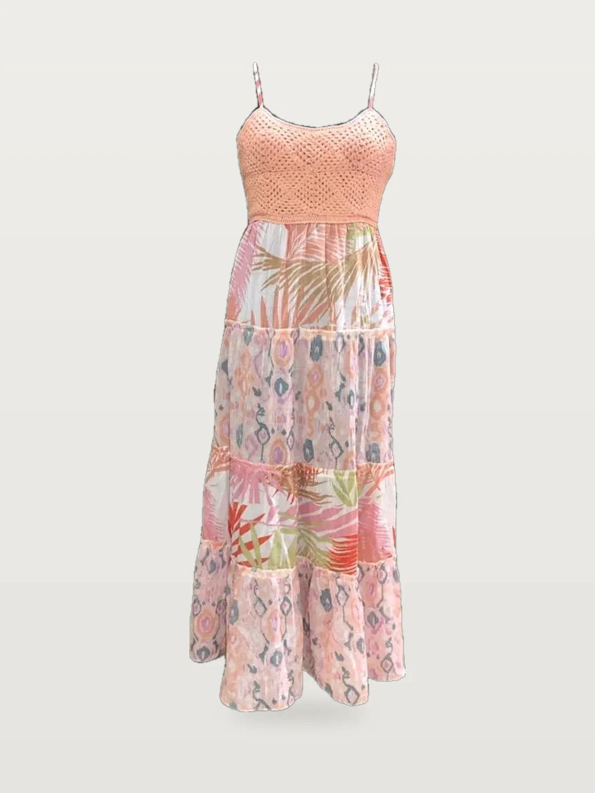 Front view of a coral crochet-bodice tropical print tiered maxi dress on a dress form