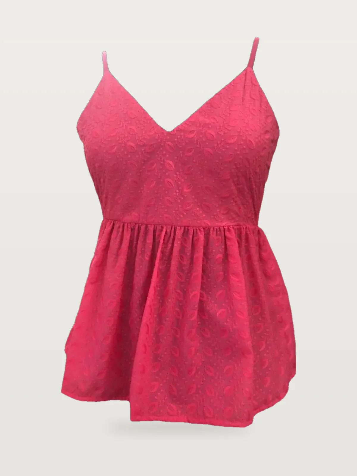 Front view of a hot pink embroidered strappy peplum cami on a dress form