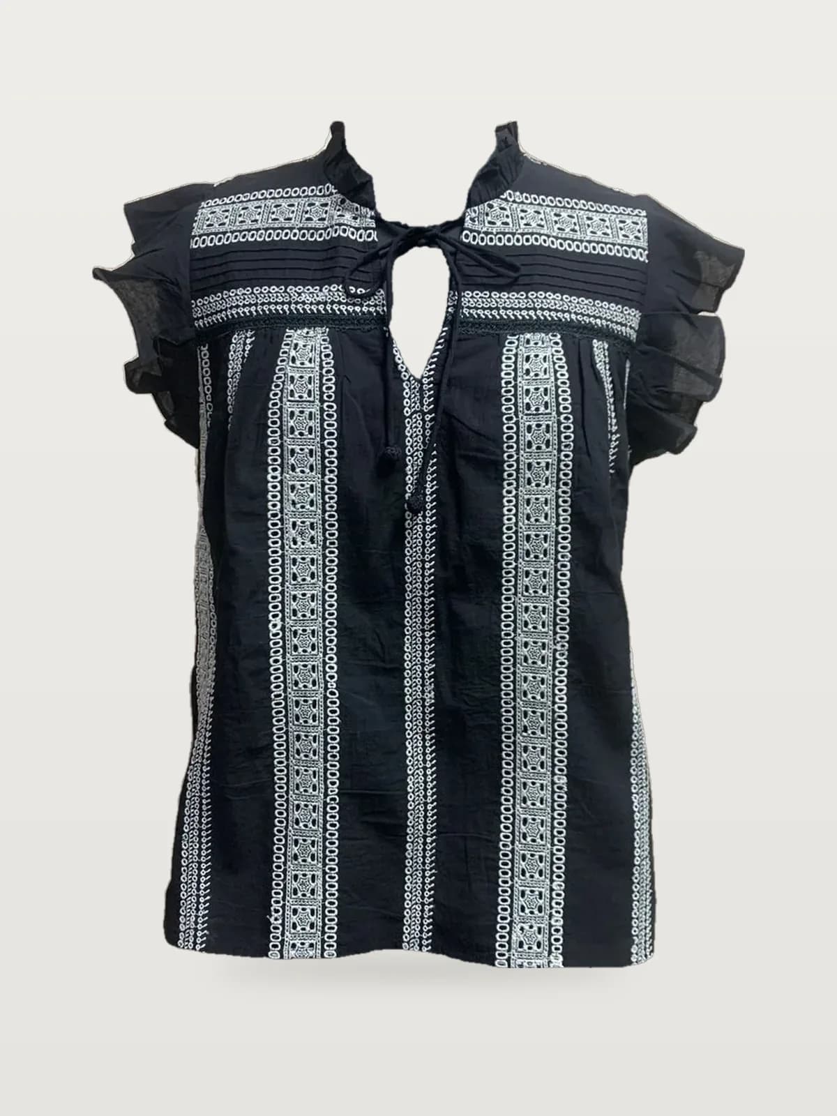 Front view of a black and white embroidered-stripe flutter-sleeve blouse on a dress form