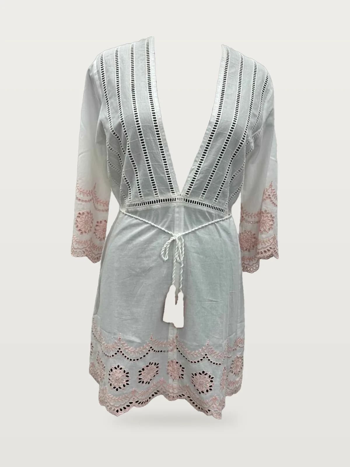 Front view of a white and pink eyelet plunge-neck tunic cover-up on a dress form