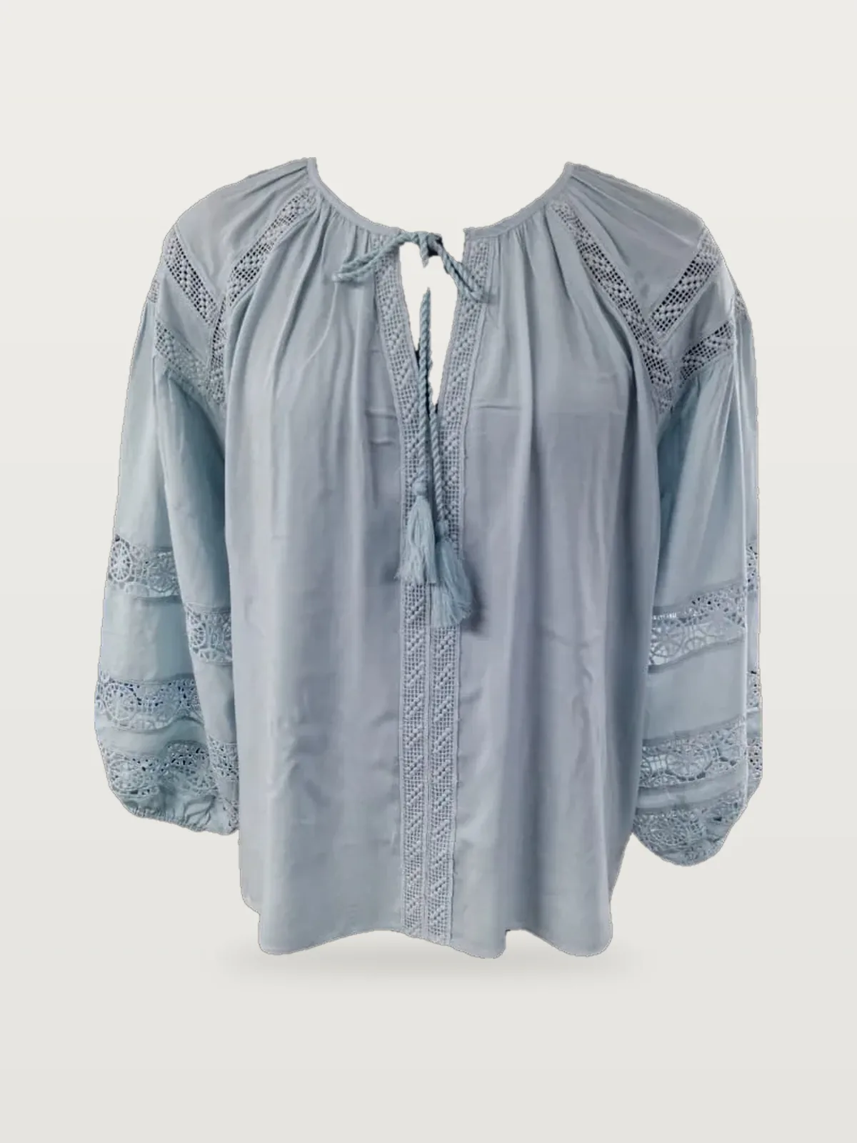 Front view of a light blue lace-insertion tie-neck blouse on a dress form