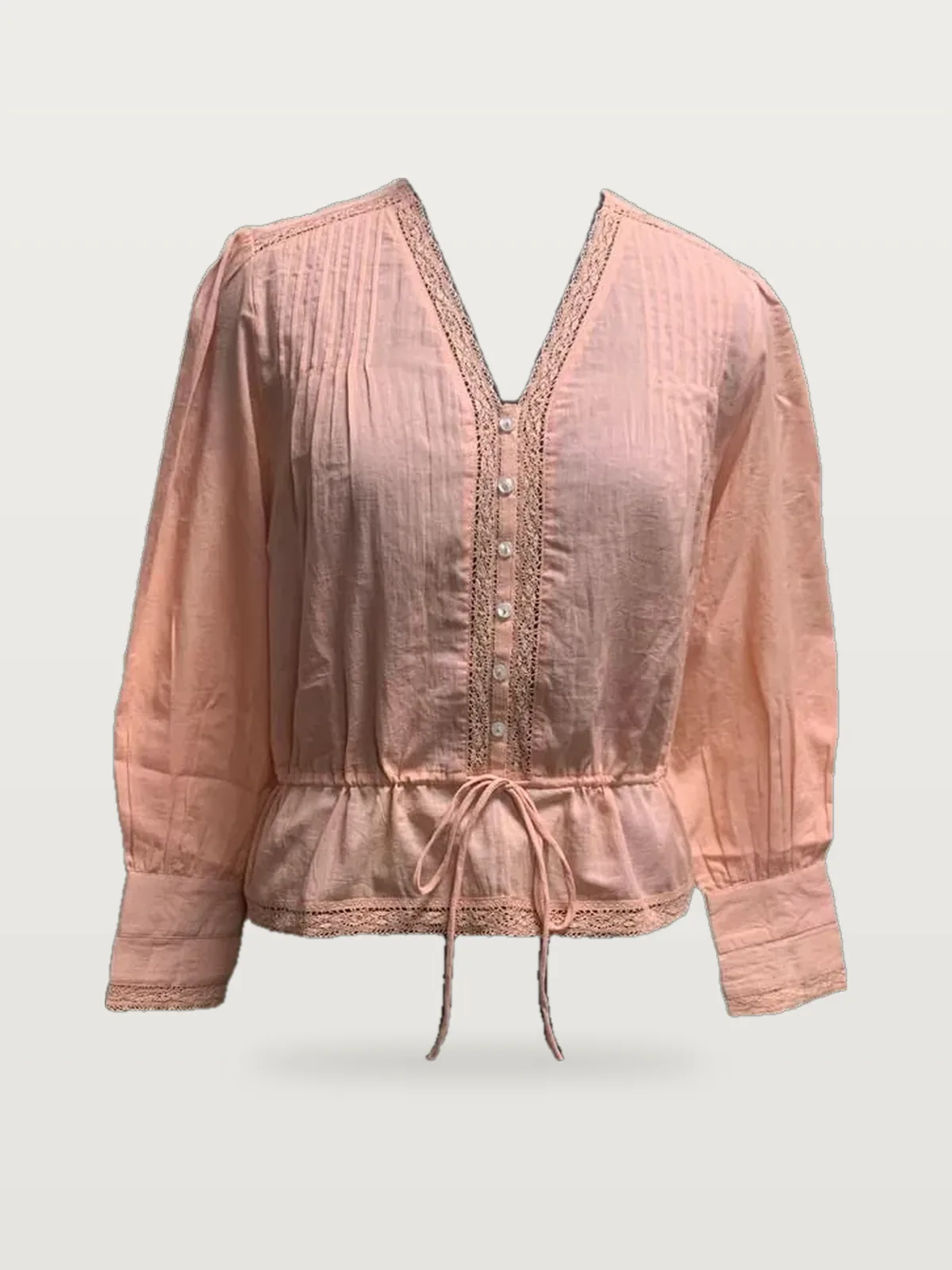 Front view of a peach lace-trim drawstring-waist blouse on a dress form