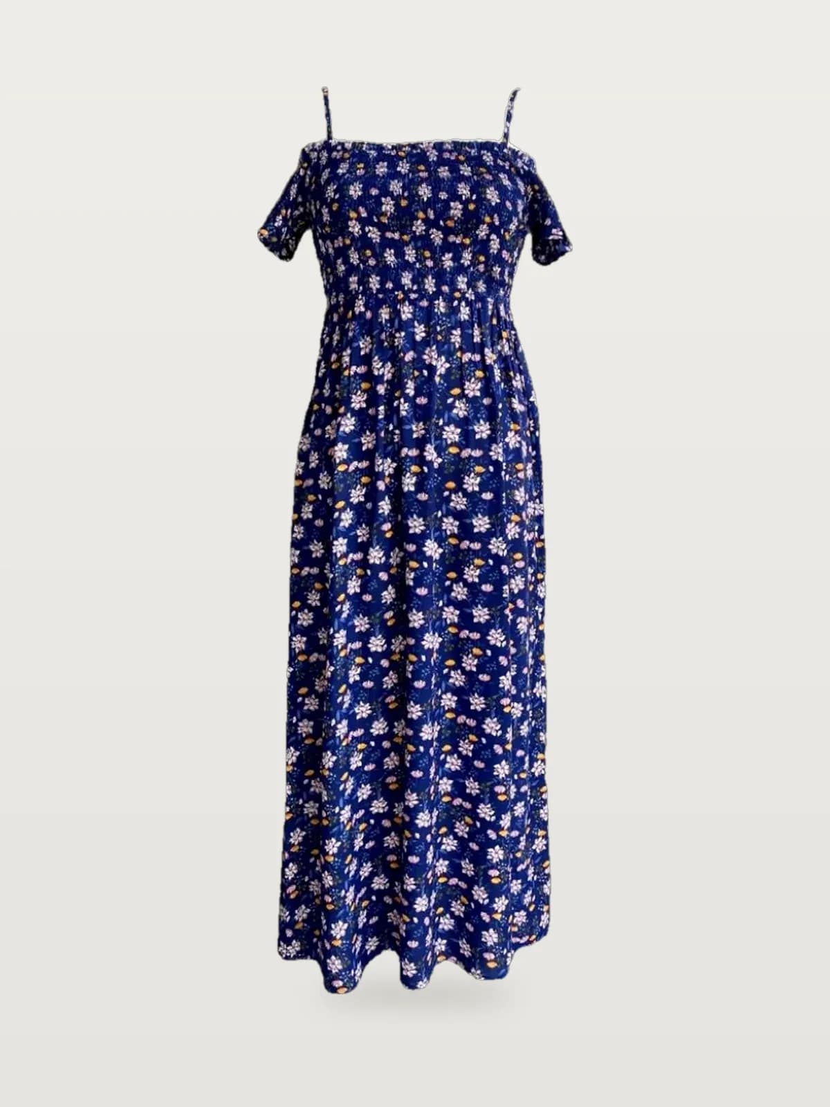 Front view of a navy floral off-shoulder smocked floral maxi dress on a dress form