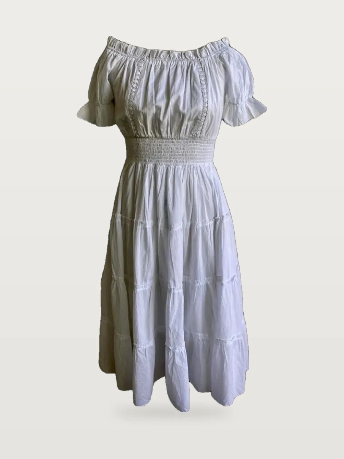 Front view of a white off-shoulder tiered midi dress with lace insertion on a dress form