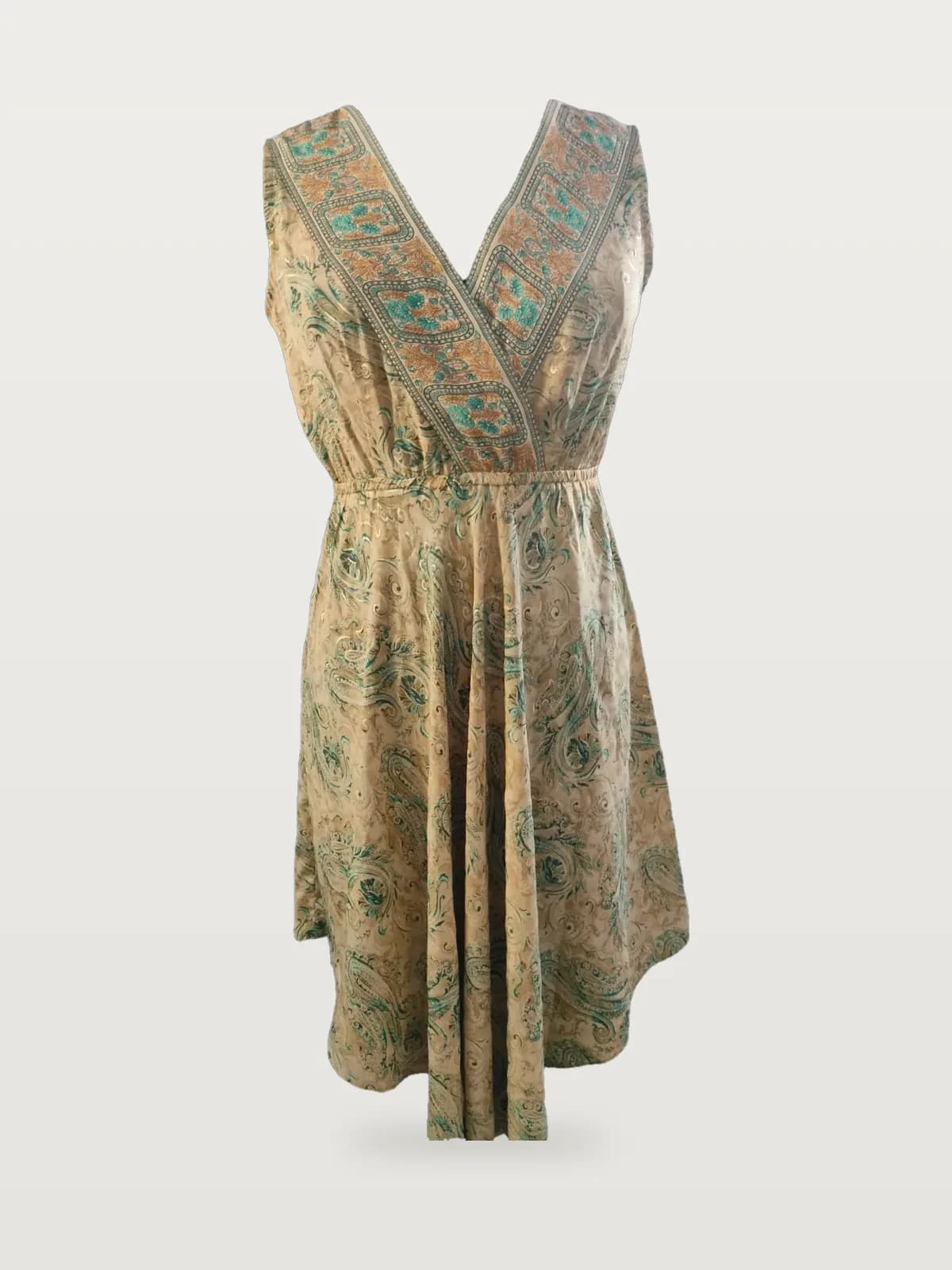 Front view of a gold and green paisley sleeveless wrap midi dress on a dress form