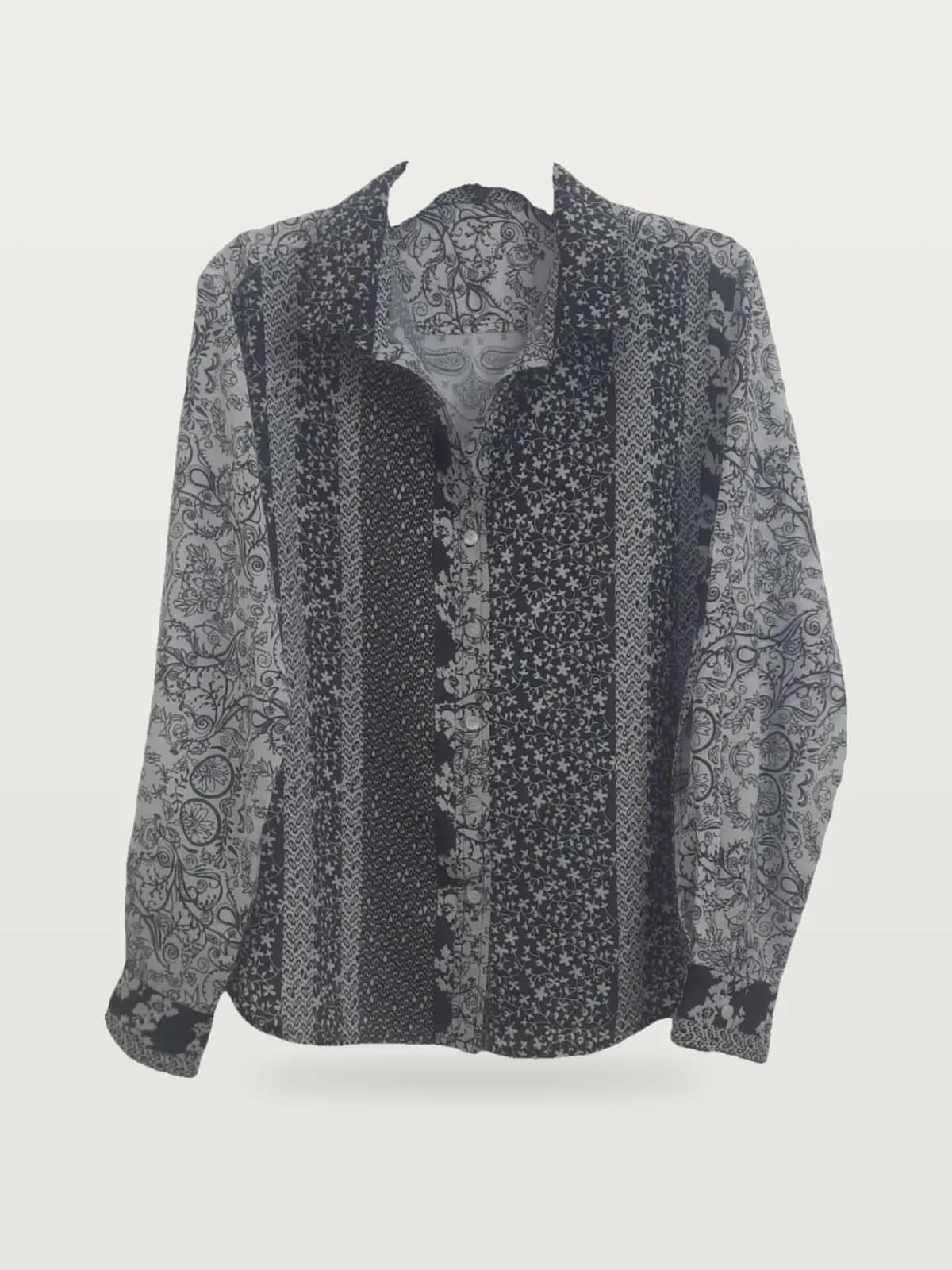 Front view of a black and white patchwork-print long-sleeve shirt on a hanger