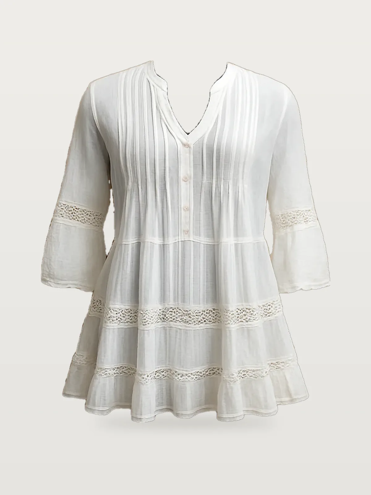 Front view of a white pintuck lace-trim tunic top on a dress form