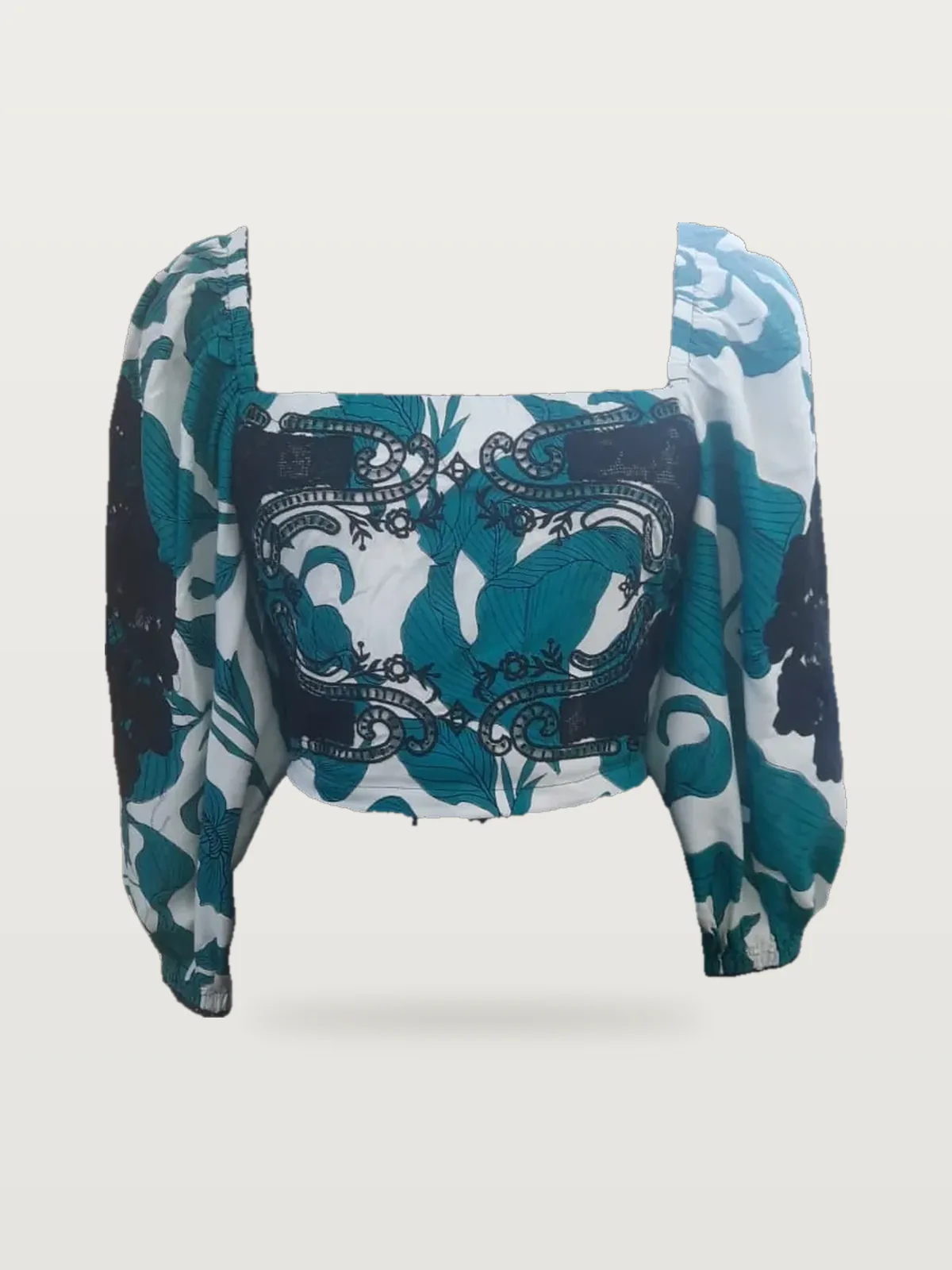 Front view of a teal and white print square-neck crop top with lace appliqué on a dress form