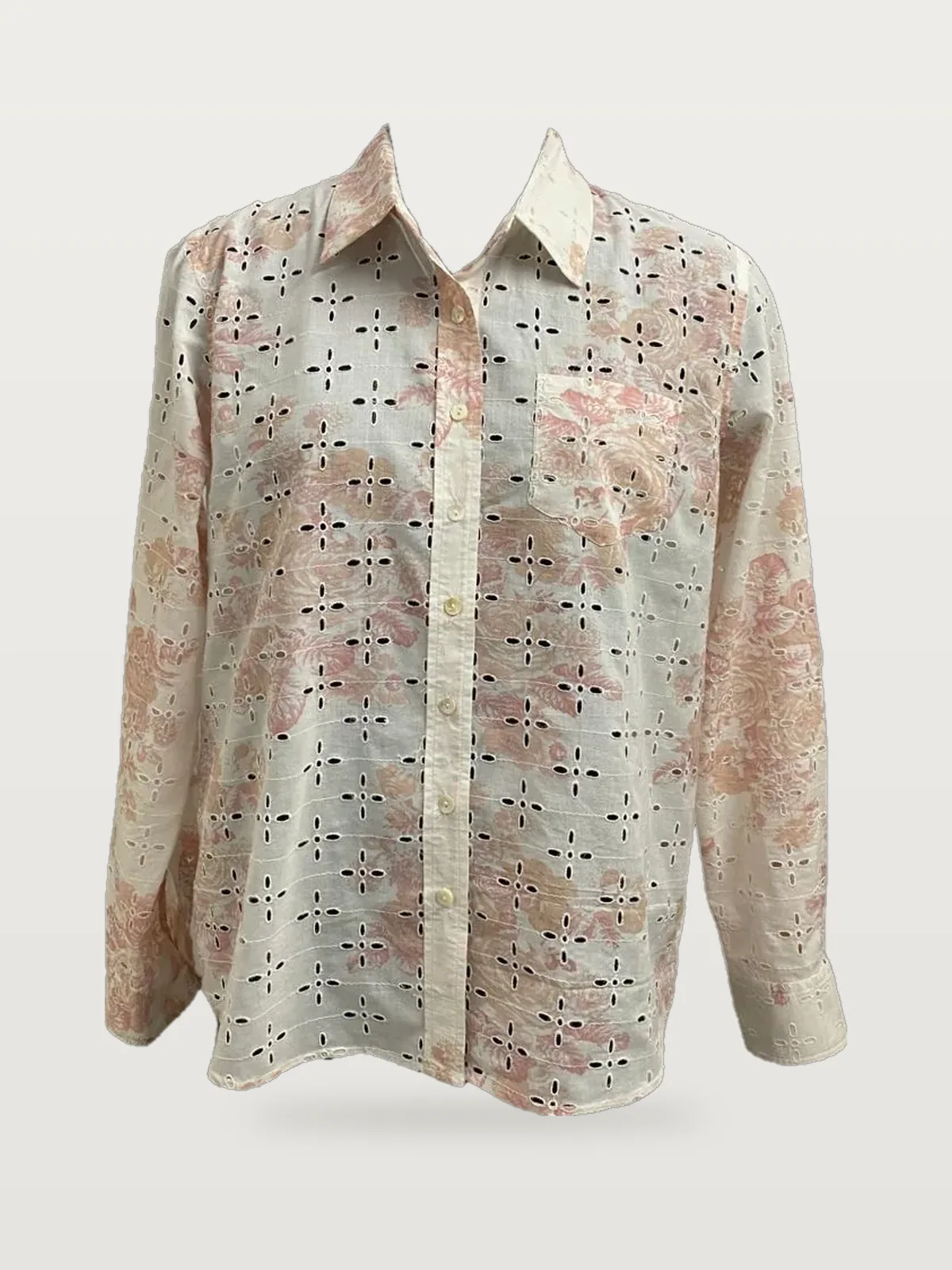 Front view of a cream and pink printed eyelet button-down shirt on a dress form