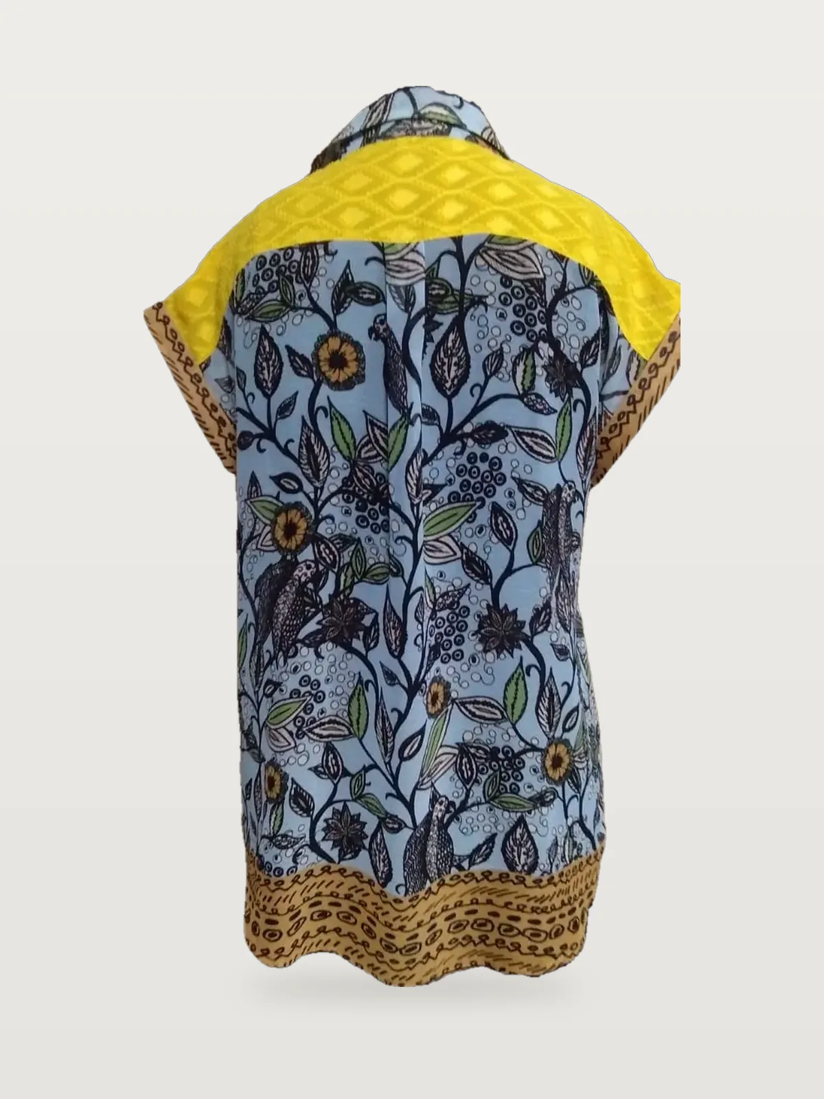 Back view of a blue and yellow printed shirt with lace yoke on a dress form