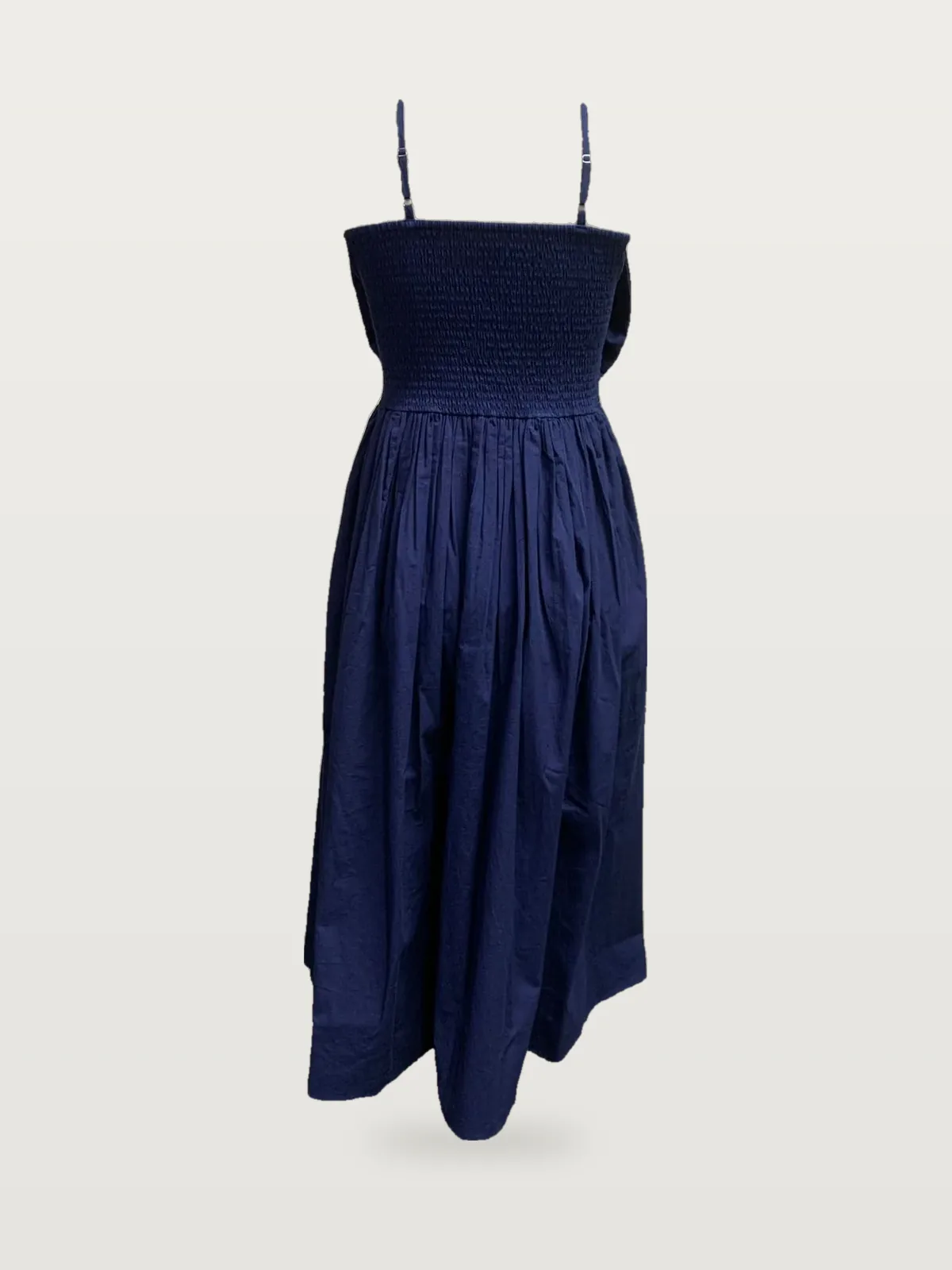Back view of a navy smocked-back strappy maxi dress on a dress form