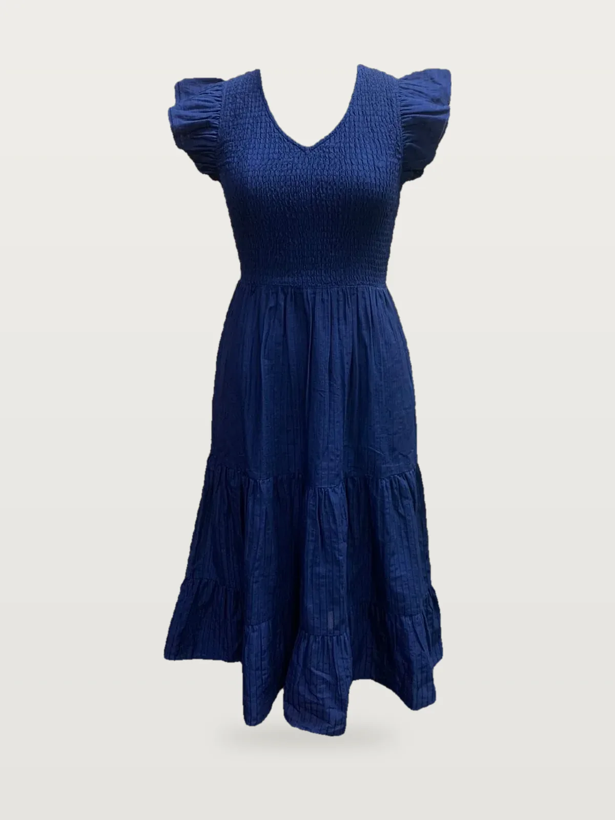 Front view of a navy smocked flutter-sleeve tiered maxi dress on a dress form