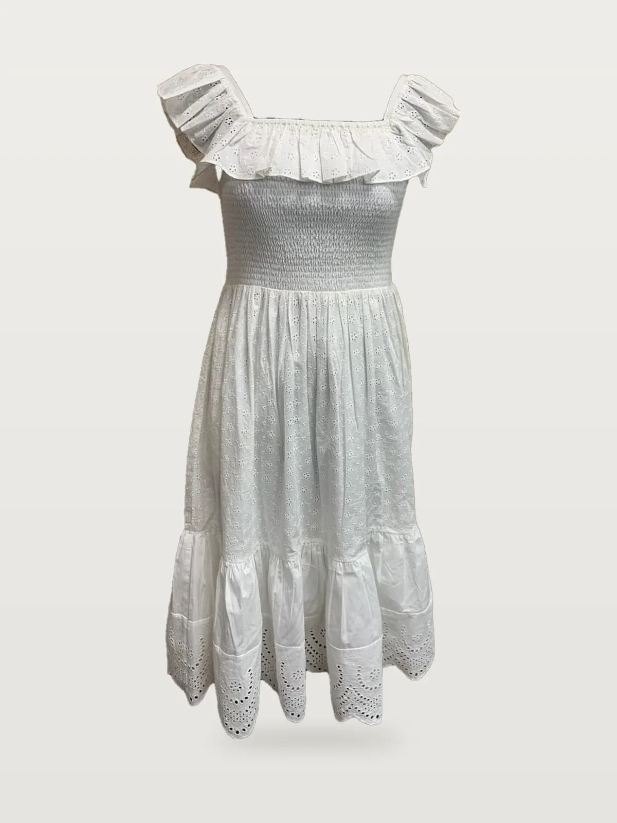 Front view of a white smocked ruffle-strap midi dress with eyelet hem on a dress form