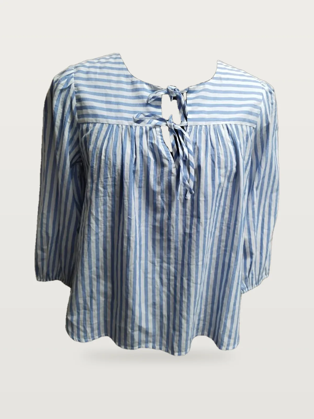 Front view of a blue and white stripe striped tie-neck peasant blouse on a dress form