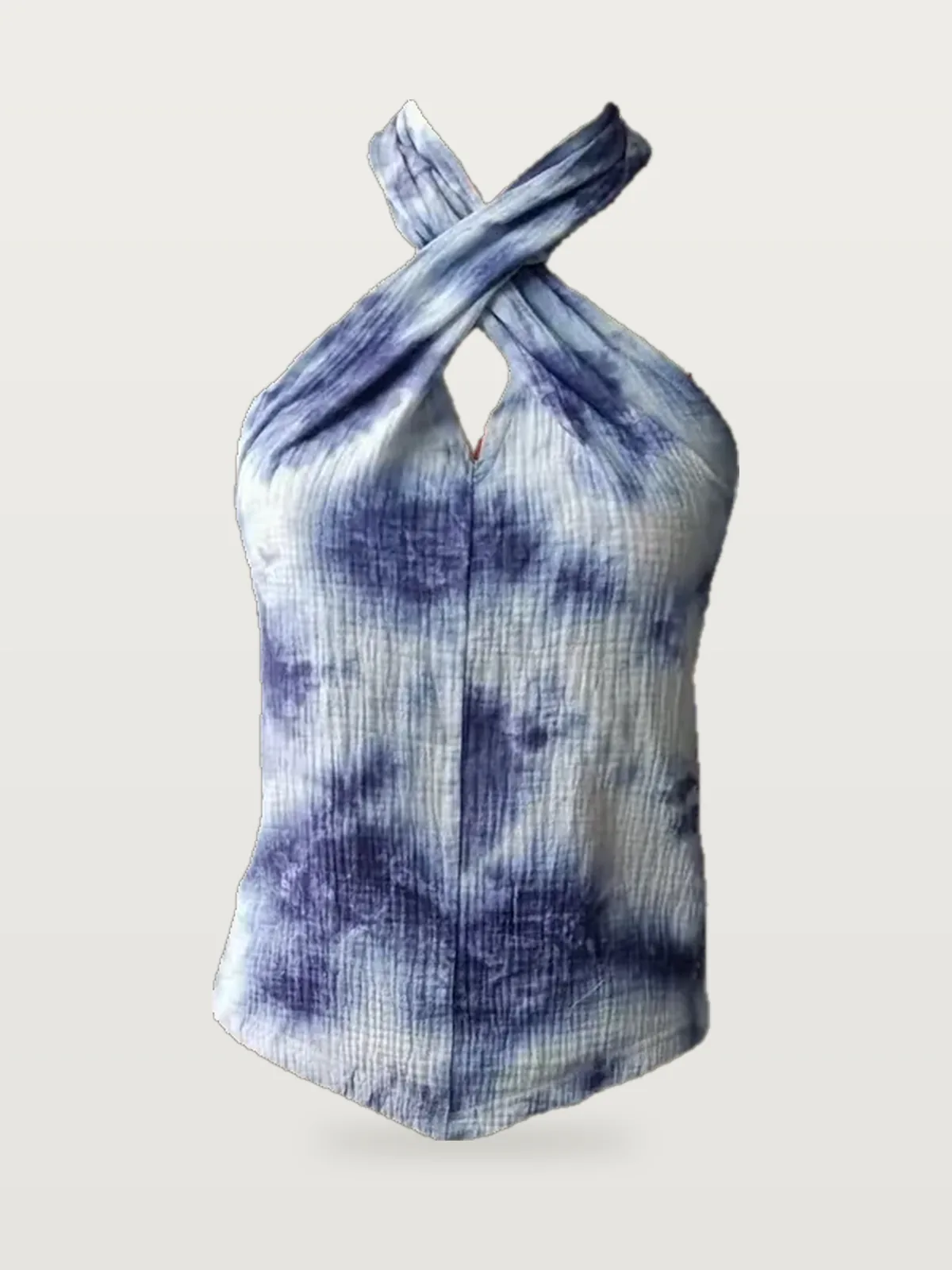 Front view of an indigo tie-dye cross-halter top on a dress form