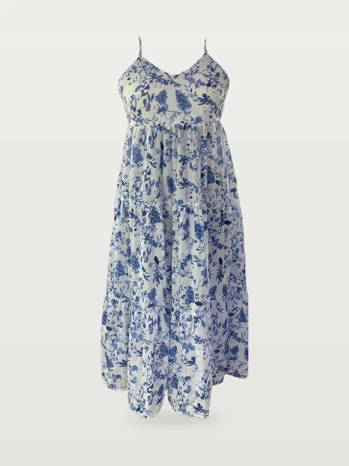 Front view of a blue and white toile floral strappy tiered maxi dress on a dress form