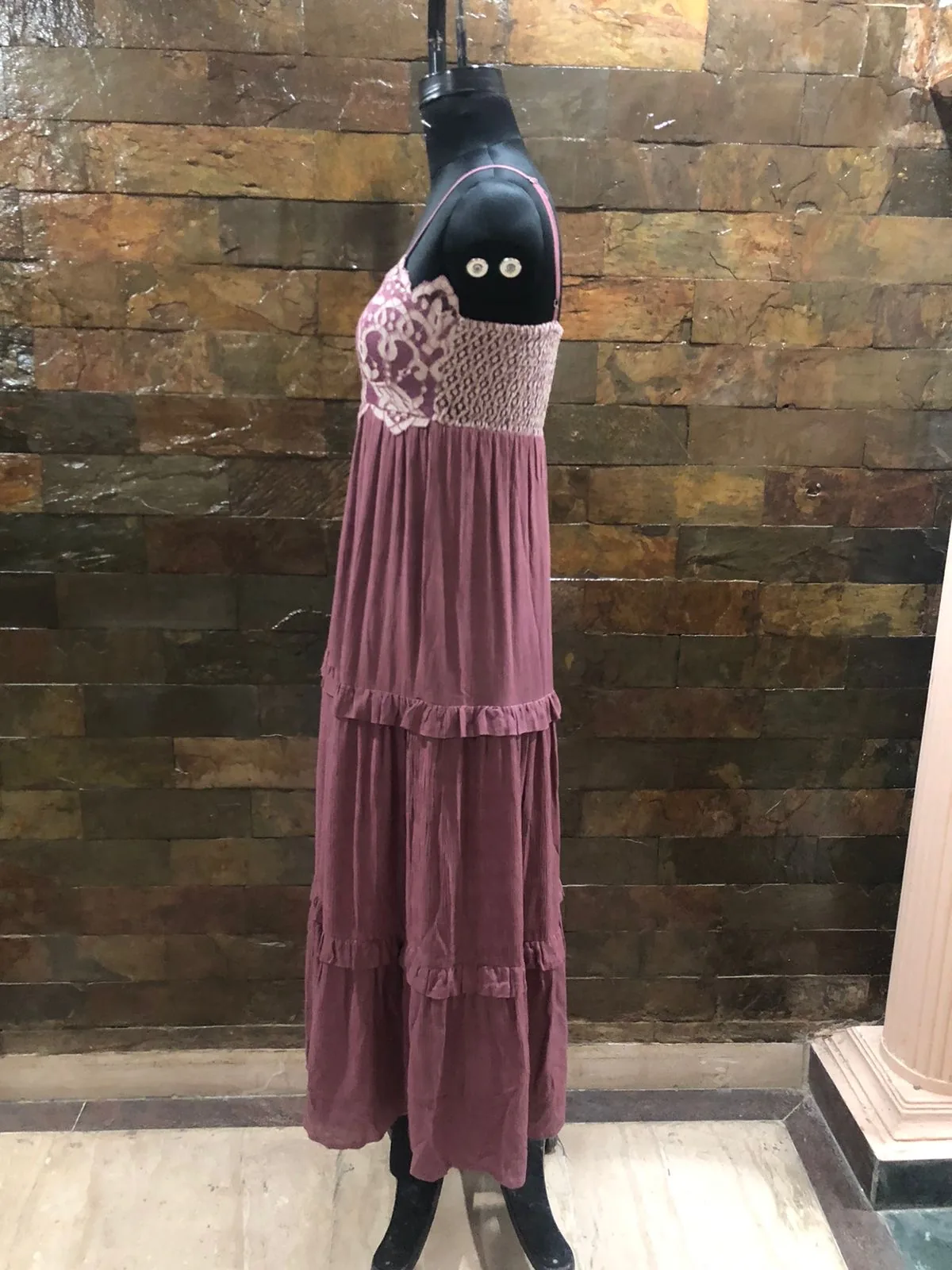 Side view of a mauve crinkle tiered maxi dress with lace bodice on a dress form